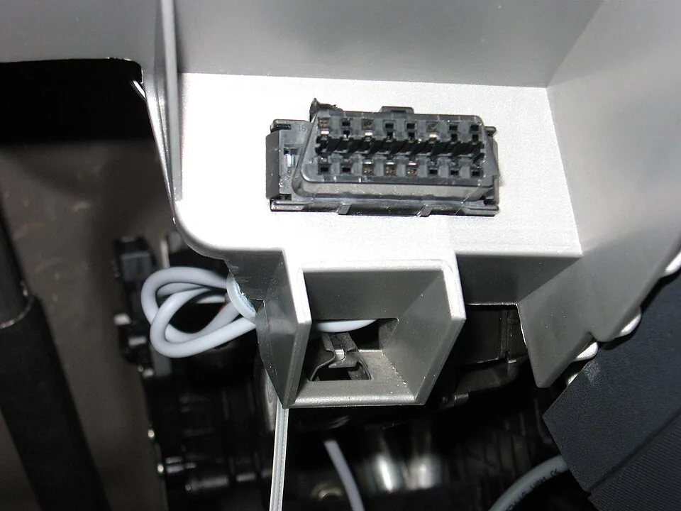 Close-up of a sixteen-pin OBD-II diagnostic connector